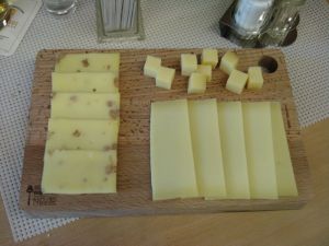 Ein Holzbrett mit verschiedenen Käsesorten zum Probieren